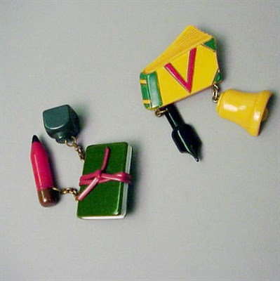 Lot 555 - Two Bakelite Brooches Each depicting a book...