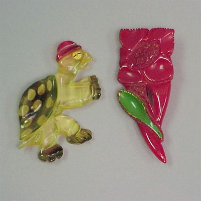Lot 415 - Two Bakelite Brooches One with floral...