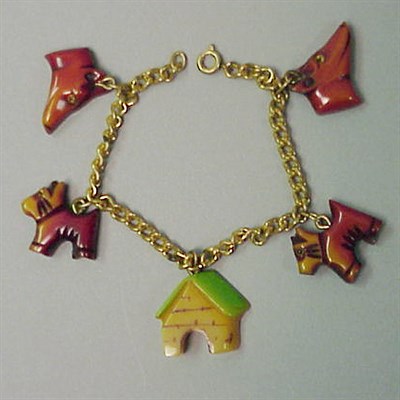 Lot 530 - Bakelite Bracelet The chain suspending various...