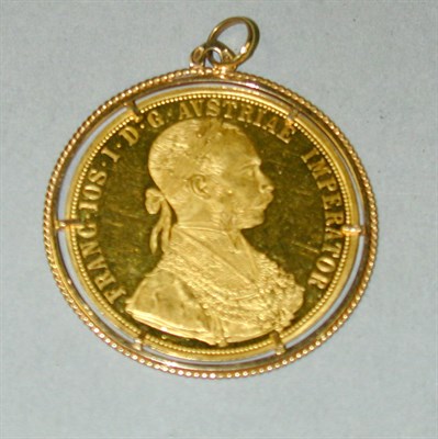 Lot 200 - Gold Coin Pendant The 18 kt. yellow gold frame...