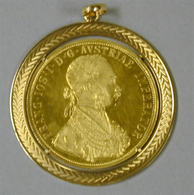Lot 82 - Gold Coin Pendant The 18 kt. yellow gold frame...