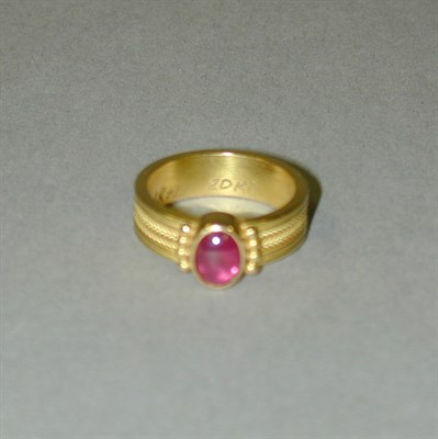 Lot 178 - Gold and Cabochon Rubellite Ring 20 kt. yellow...