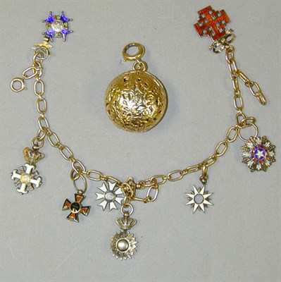 Lot 58 - Gold Charm Bracelet and Lapel Watch 14 kt....