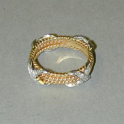 Lot 298 - Gold and Diamond 'Three Rows Rope' Ring 18 kt....