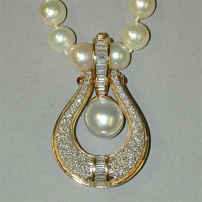 Lot 307 - Pearl Necklace and Diamond Enhancer The single...