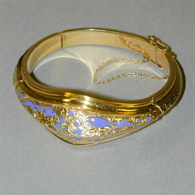 Lot 126 - Blue Enamel Bangle Bracelet The 18 kt. yellow...