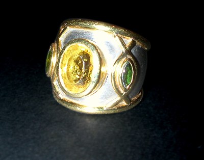 Lot 259 - Citrine and Tourmaline Ring The wide platinum...