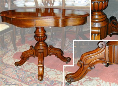 Lot 665 - Victorian Walnut Center Table The shaped oval...