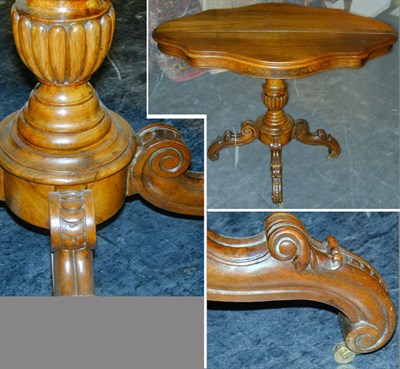 Lot 670 - Victorian Walnut Center Table The shaped oval...