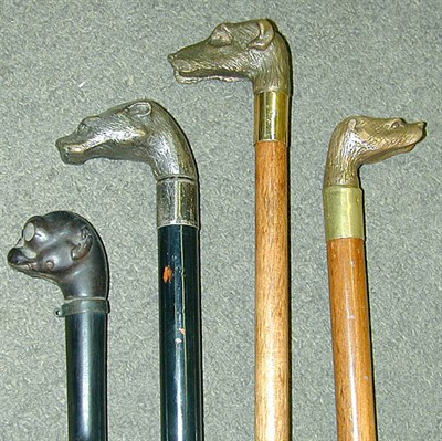 Lot 4 - Group of Four Walking Canes Each with dog's...
