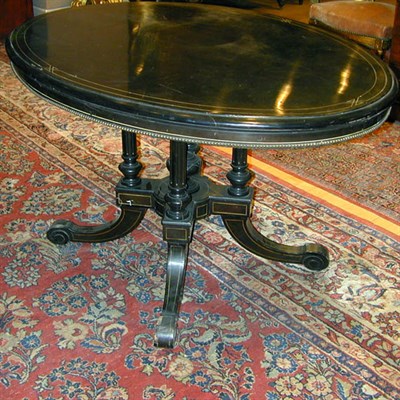 Lot 605 - Napoleon III Ebonized Center Table The oval...
