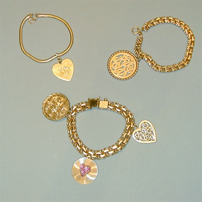 Lot 210 - Three Gold Bracelets with Charms 14 kt. yellow...