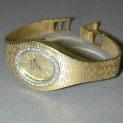 Lot 165 - Lady's Gold and Diamond Bracelet Watch 14 kt....