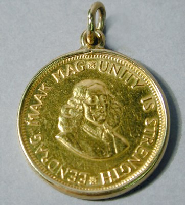Lot 18 - Gold Coin Pendant The 14 kt. yellow gold frame...