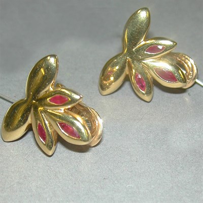 Lot 267 - Pair of Gold and Ruby Earclips 18 kt. yellow...