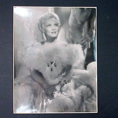 Lot 102 - DIETRICH, MARLENE Bust length photograph in...
