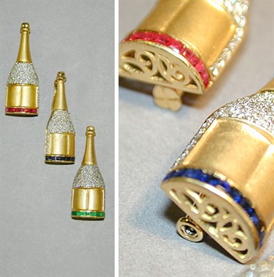 Lot 265 - Three Champagne Bottle Pins 18 kt. yellow gold,...
