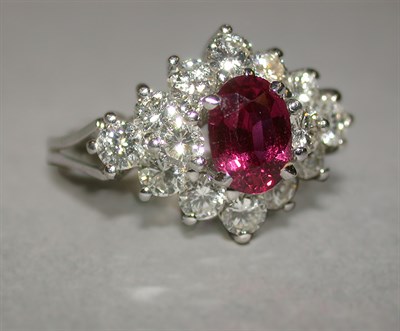 Lot 316 - Ruby and Diamond Cluster Ring 18 kt. white...