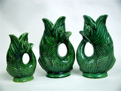 Lot 481 - Three Dartmouth Pottery Fish Pitchers Each...