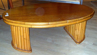 Lot 101 - Wood and Bamboo Low Table The oval top raised...