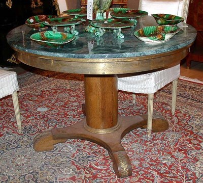 Lot 651 - Empire Style Oak Table The circular marble top...