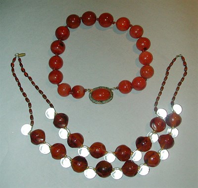 Lot 369 - Two Large Bead Necklaces The first a single...