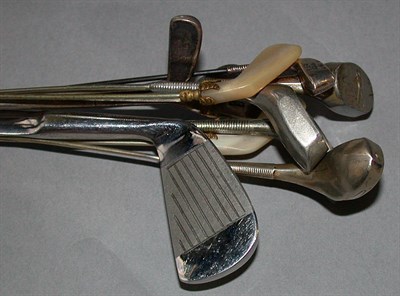 Lot 512 - Four silver wood club hatpins, the soles...