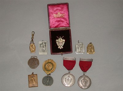 Lot 513 - A 9ct. gold shield shaped medal surmounted by...