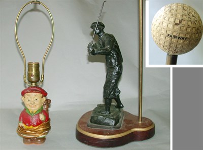 Lot 521 - A cast iron cartoon man lamp base; and another...