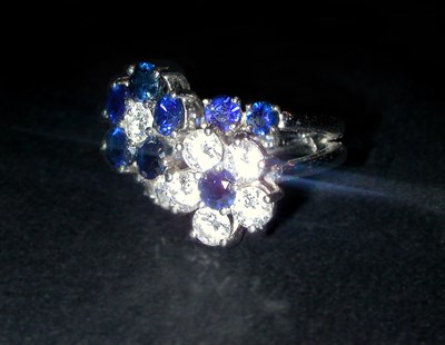 Lot 434 - Diamond and Sapphire Double Flower Ring...