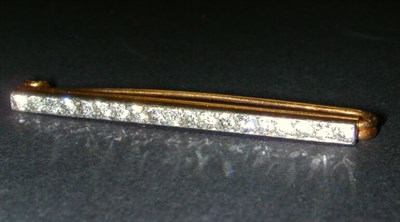 Lot 340 - Diamond Bar Pin The 18 kt. yellow gold base...