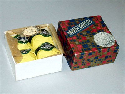 Lot 146 - A North British 4 box with four wrapped balls....