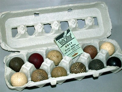 Lot 306 - A gutty ball; ten rubber practice balls...