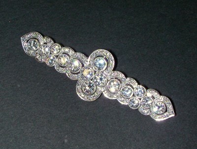Lot 422 - Diamond Bar Pin Platinum, of swirl motif, set...