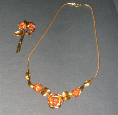 Lot 310 - Gold Flower Necklace and Pin The 14 kt. yellow...