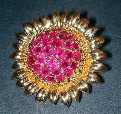 Lot 298 - Ruby Cluster Pin The 18 kt. yellow gold domed...