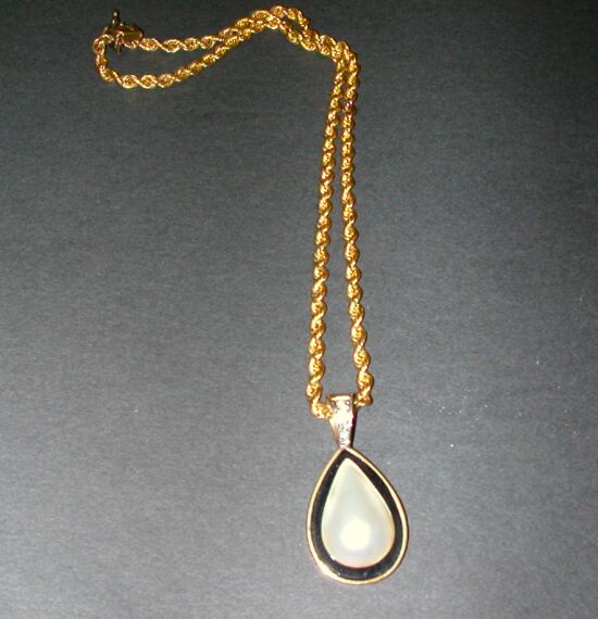Lot 89 - Black Onyx and Mabe Pearl Pendant The 14 kt....