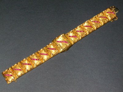 Lot 398 - Lady's Gold and Ruby Covered Wristwatch The 18...