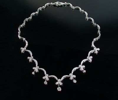 Lot 242 - Scalloped Diamond Pendant Necklace 14 kt....