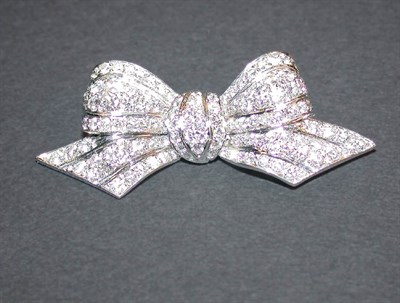 Lot 431 - Diamond Bow Pin Platinum, designed as a tied...