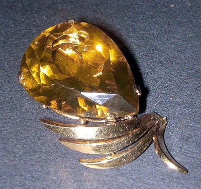 Lot 57 - Citrine Pendant The 14 kt. yellow gold frame...