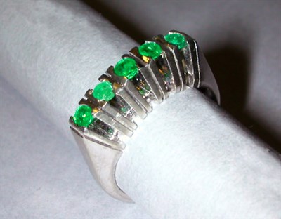 Lot 91A - Emerald Ring The narrow 18 kt. white gold band...