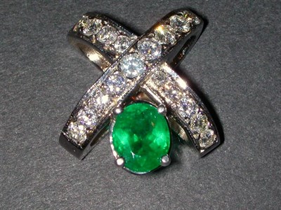 Lot 382 - Diamond and Emerald Slide 14 kt. white gold,...