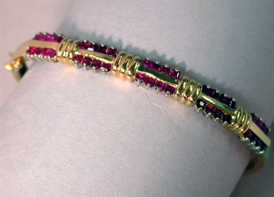 Lot 307 - Gold and Ruby Bangle Bracelet 14 kt. yellow...