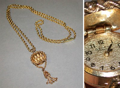 Lot 139 - Lady's Gold Pendant Watch and Chain 14 kt....