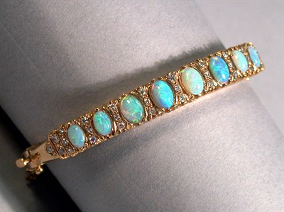 Lot 185 - Opal and Diamond Bangle Bracelet 14 kt. yellow...