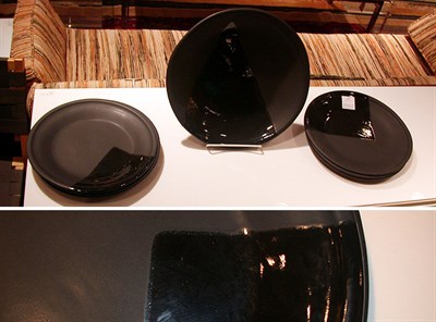 Lot 119 - Set of Six Black Pottery Plates and Charger
