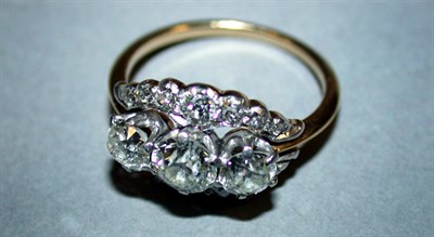 Lot 250 - Three Stone Diamond Ring The 14 kt. yellow...