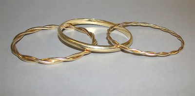 Lot 318 - Three Gold Bangle Bracelets