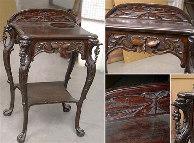 Lot 1183 - Art Nouveau Mahogany Table The shaped crest...